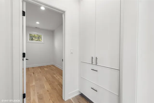 a view of a kitchen with white cabinets