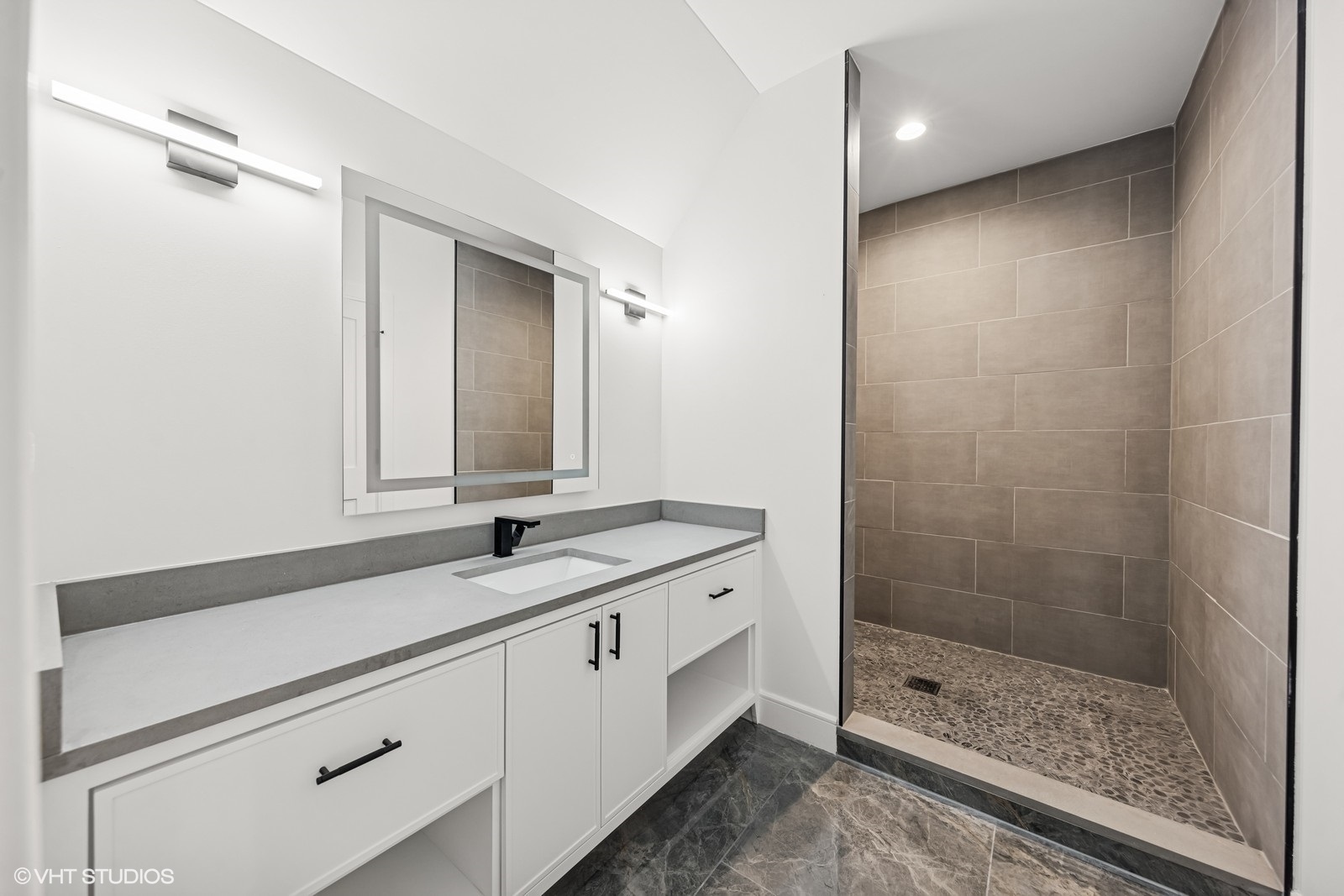 936 Mitchell Avenue Elmhurst, IL 60126 - Photo 26 of 44 a bathroom with a granite countertop sink a mirror and a shower