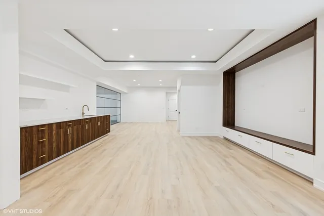 a bathroom with a shower sink vanity mirror and toilet