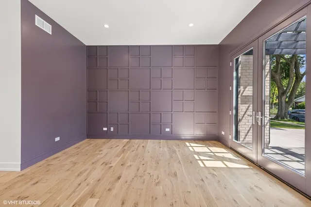 a view of a bathroom with wooden floor and a tub