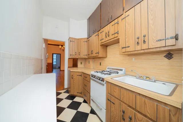 a kitchen with stainless steel appliances a stove a sink and a refrigerator