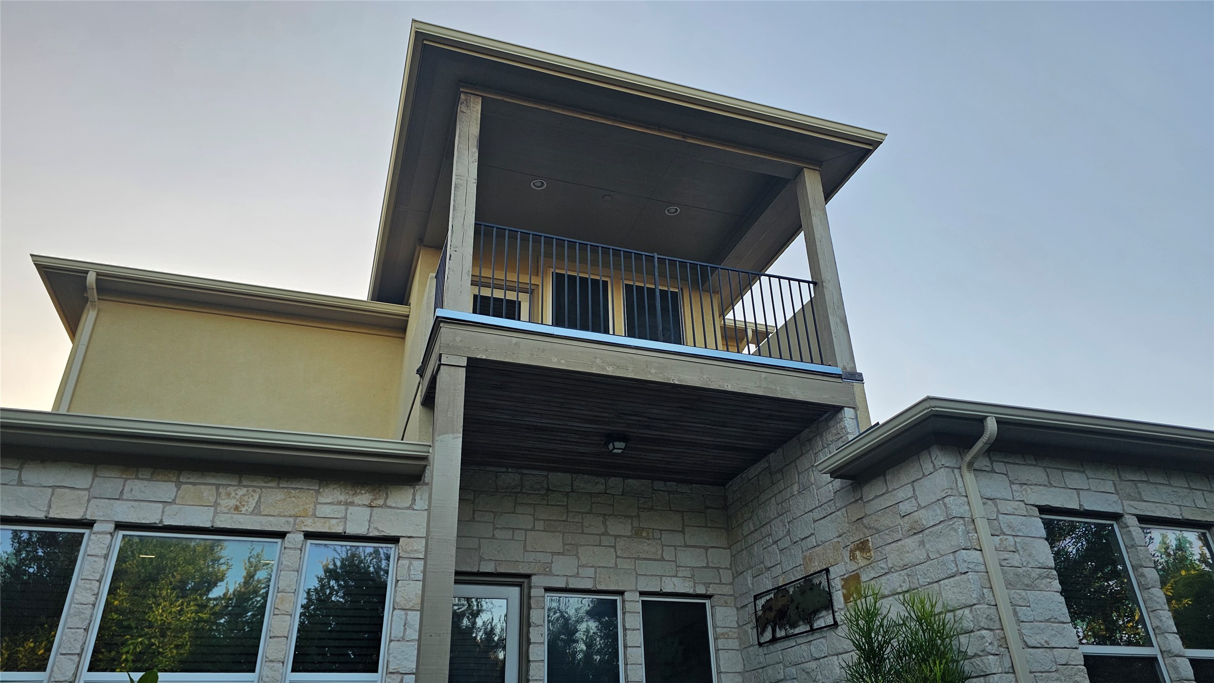 5821 Buchanan Draw Road Austin, TX 78738 - Photo 17 of 18 Stone and stucco exterior create a distinguished facade with an upper-level balcony providing elevated outdoor living.