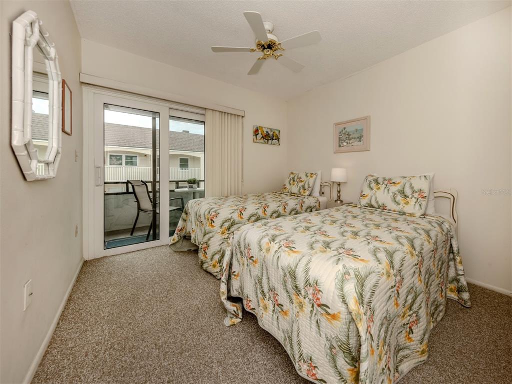 1555 Tarpon Center Drive, Unit 261 Venice, FL 34285 - Photo 18 of 50 a bedroom with a bed mirror and a window