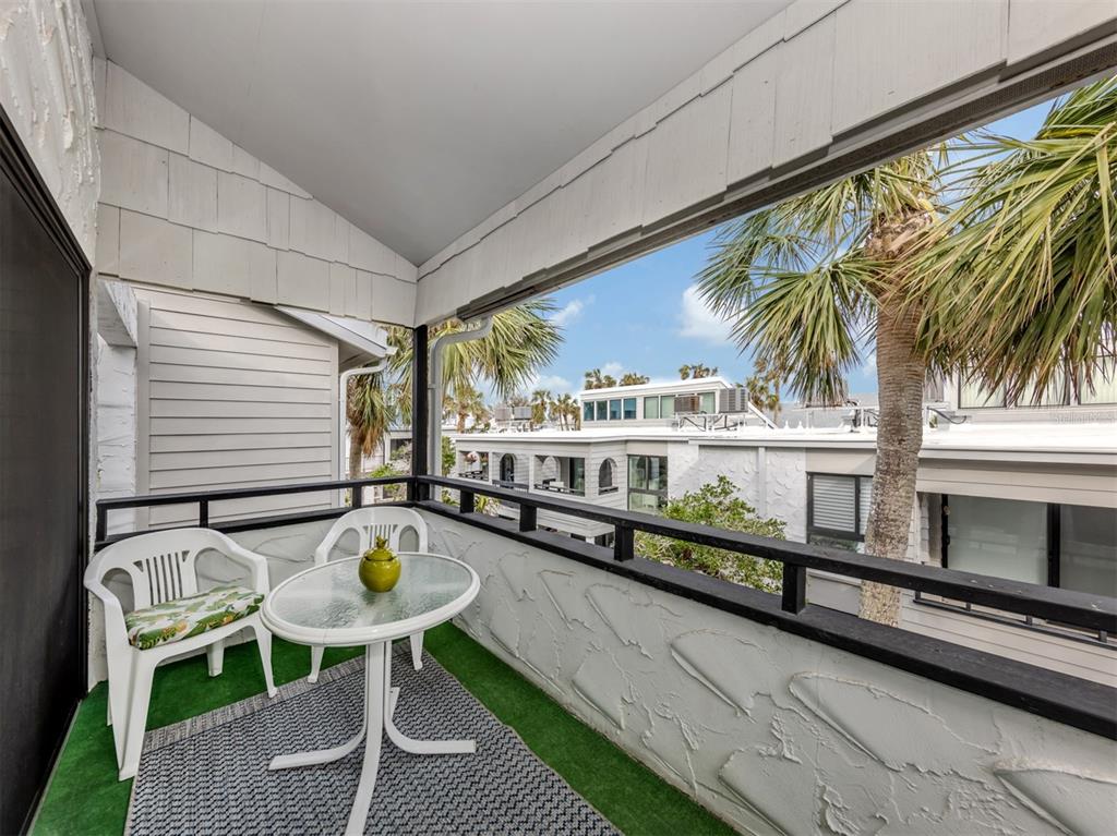 1555 Tarpon Center Drive, Unit 261 Venice, FL 34285 - Photo 23 of 50 a balcony with table and chairs