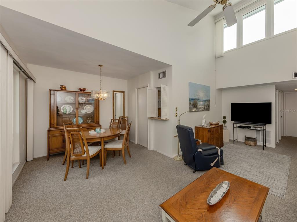 1555 Tarpon Center Drive, Unit 261 Venice, FL 34285 - Photo 10 of 50 a living room with furniture and a flat screen tv