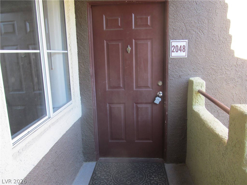 7950 West Flamingo Road, Unit 2048 Las Vegas, NV 89147 - Photo 5 of 24 Welcome home to this private entrance, featuring a classic door and convenient side window.
