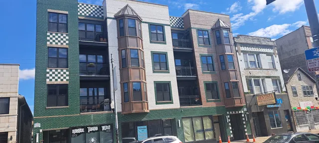 a front view of a brick building with many windows