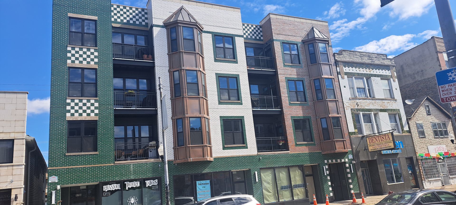 a front view of a brick building with many windows