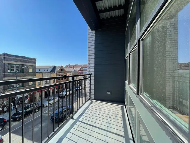 a view of a balcony with wooden floor and stairs