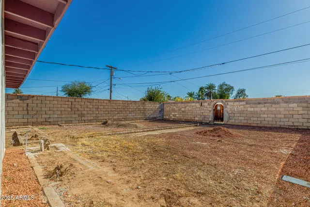 a view of a backyard space and garage