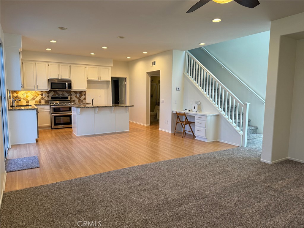 19562 Rotterdam Street Riverside, CA 92508 - Photo 2 of 11 a view of kitchen with cabinets and wooden floor