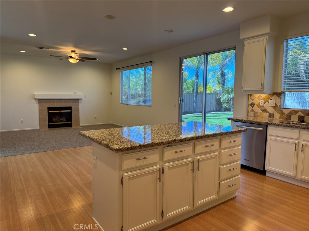 19562 Rotterdam Street Riverside, CA 92508 - Photo 4 of 11 a kitchen with granite countertop a stove a sink and a refrigerator