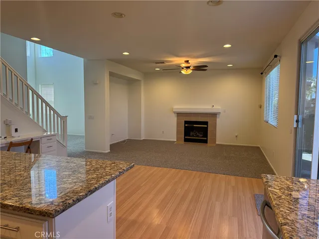 a view of kitchen and hallway with wooden floor