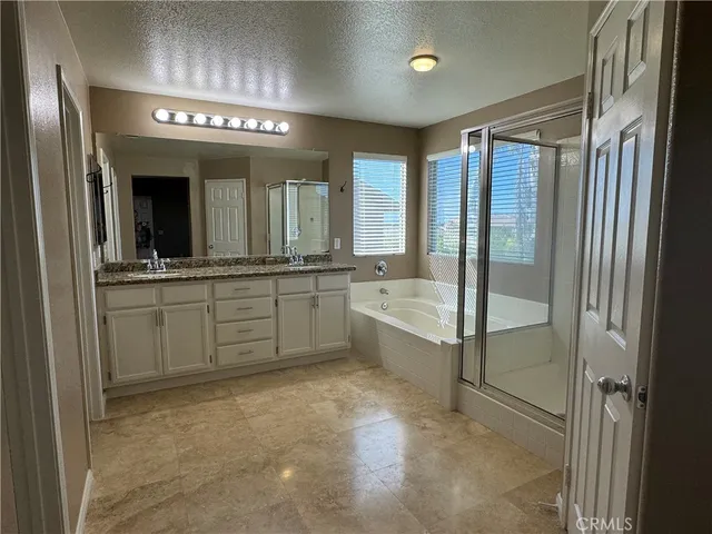 a large bathroom with a large tub and sink