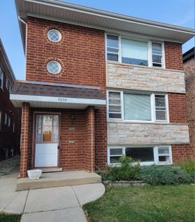 7824 West Addison Street, Unit 2 Chicago, IL 60634 - Photo 1 of 28 a front view of a house with garden