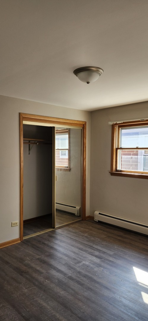 7824 West Addison Street, Unit 2 Chicago, IL 60634 - Photo 16 of 28 a view of an empty room with wooden floor and a window