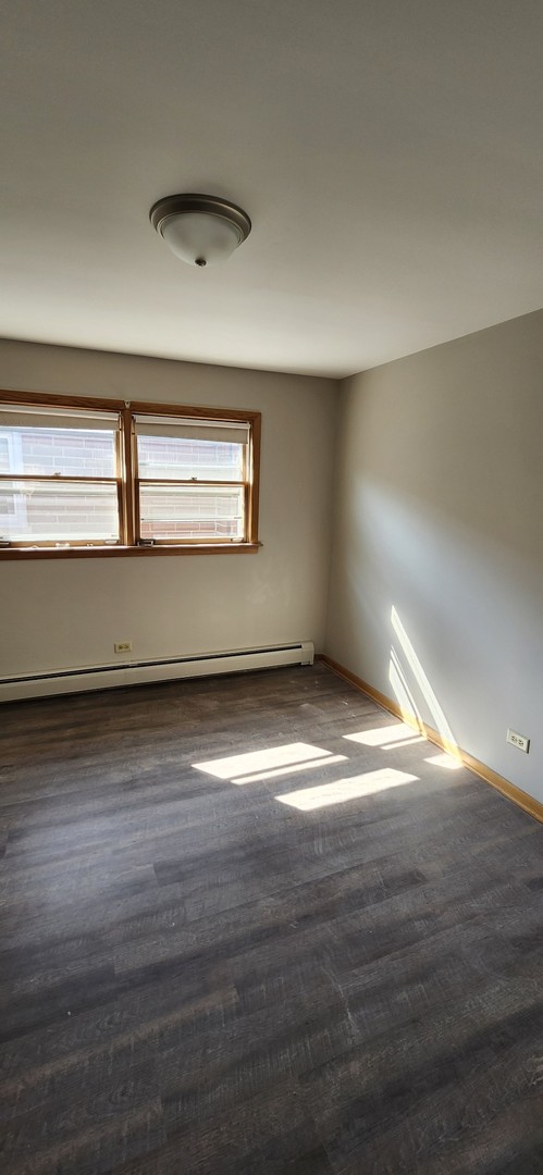 7824 West Addison Street, Unit 2 Chicago, IL 60634 - Photo 17 of 28 a view of empty room with wooden floor