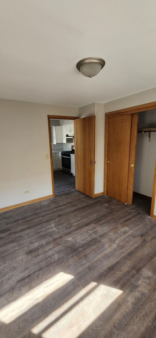 7824 West Addison Street, Unit 2 Chicago, IL 60634 - Photo 20 of 28 a view of a livingroom with wooden floor and a ceiling fan