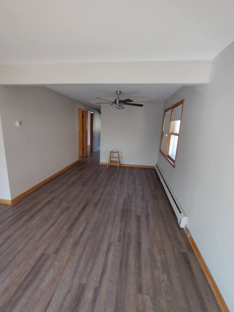 7824 West Addison Street, Unit 2 Chicago, IL 60634 - Photo 21 of 28 wooden floor in an empty room with a window