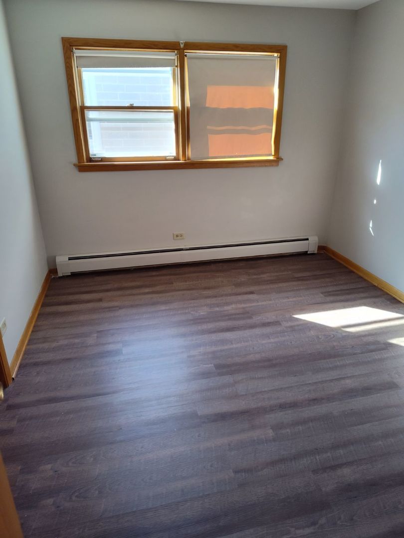7824 West Addison Street, Unit 2 Chicago, IL 60634 - Photo 22 of 28 a view of a room with wooden floors and window