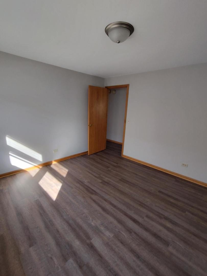 7824 West Addison Street, Unit 2 Chicago, IL 60634 - Photo 25 of 28 a view of empty room with wooden floor and fan