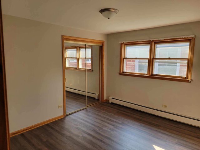 7824 West Addison Street, Unit 2 Chicago, IL 60634 - Photo 28 of 28 an empty room with wooden floor and windows