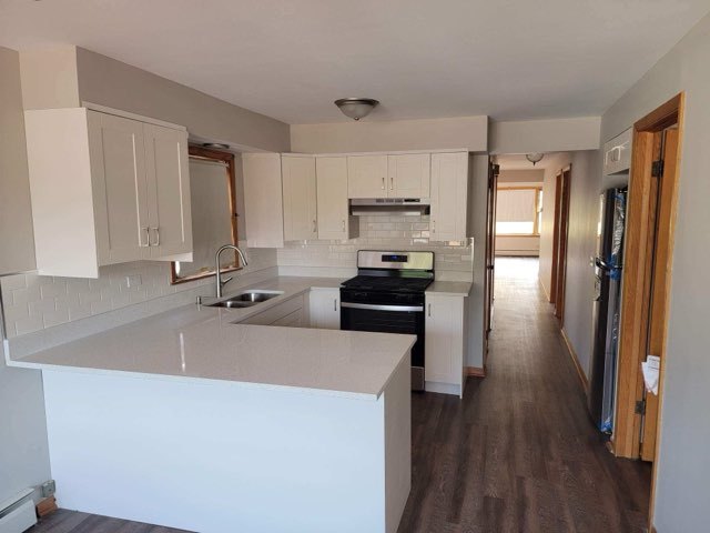 7824 West Addison Street, Unit 2 Chicago, IL 60634 - Photo 6 of 28 a kitchen with stainless steel appliances a sink stove and refrigerator