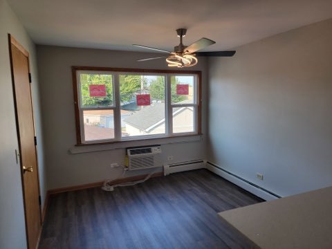 7824 West Addison Street, Unit 2 Chicago, IL 60634 - Photo 7 of 28 wooden floor in an empty room with a window
