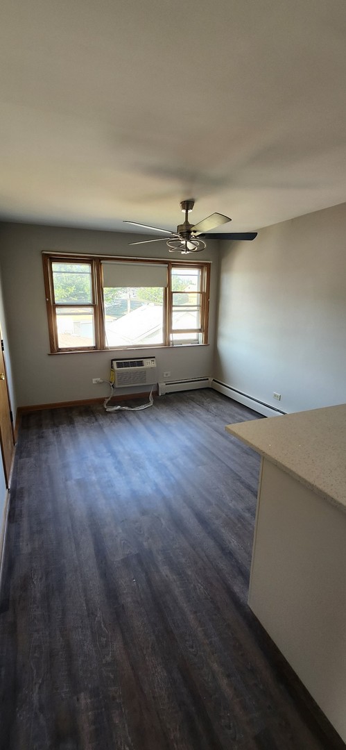 7824 West Addison Street, Unit 2 Chicago, IL 60634 - Photo 9 of 28 an empty room with wooden floor and windows