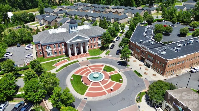 an aerial view of multiple houses with yard