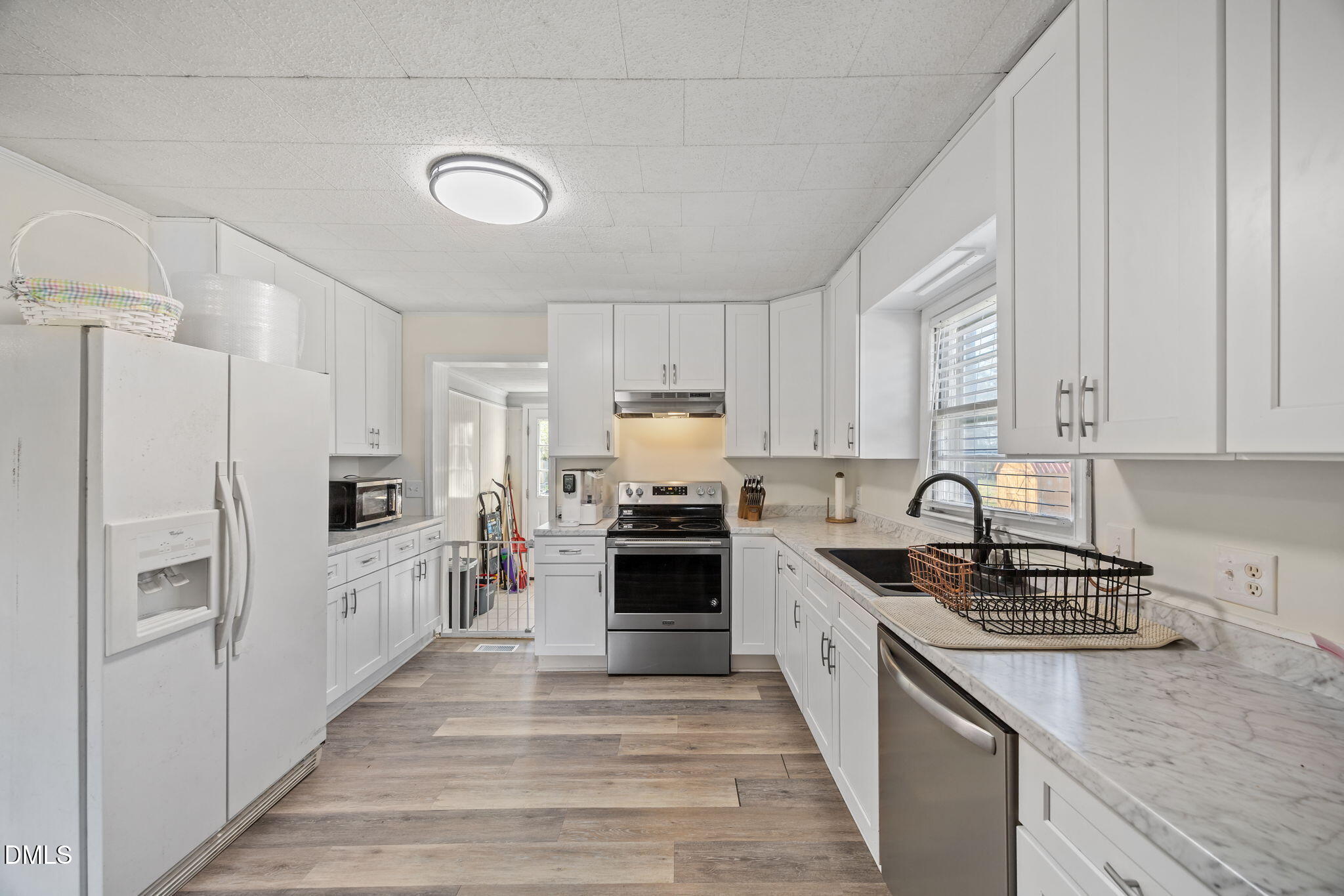 2727 Highway 87 Graham, NC 27253 - Photo 12 of 28 a kitchen with white cabinets and stainless steel appliances