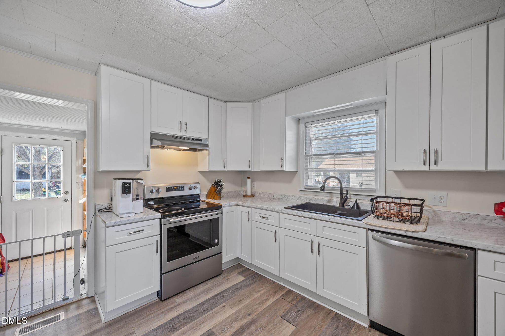 2727 Highway 87 Graham, NC 27253 - Photo 13 of 28 a kitchen with granite countertop white cabinets white stainless steel appliances and sink