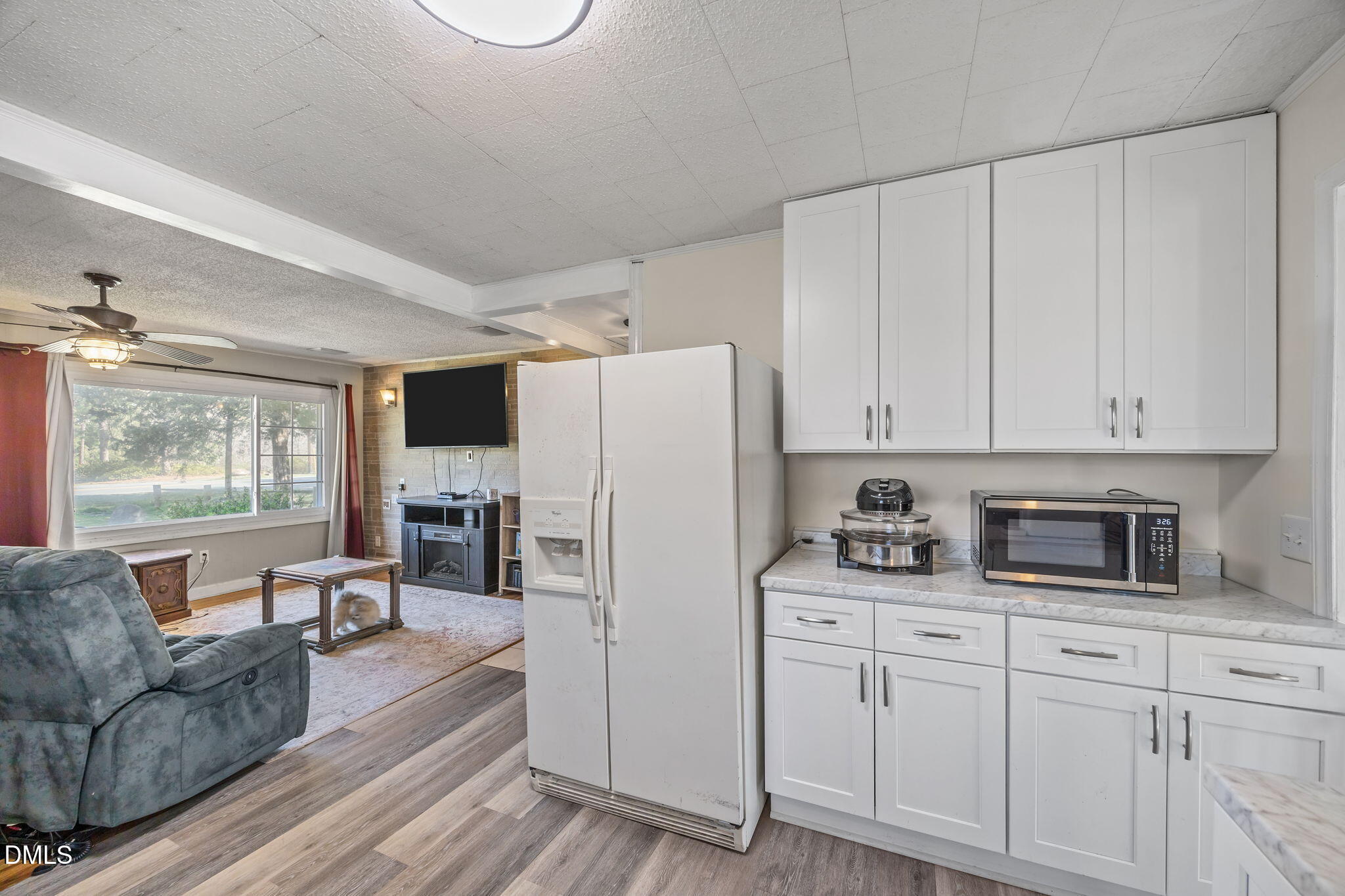 2727 Highway 87 Graham, NC 27253 - Photo 14 of 28 a living room with furniture a fireplace a flat screen tv and windows