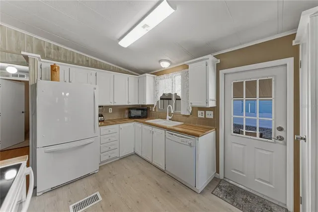 a kitchen with granite countertop a sink and white stainless steel appliances