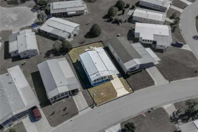 an aerial view of a house with outdoor space