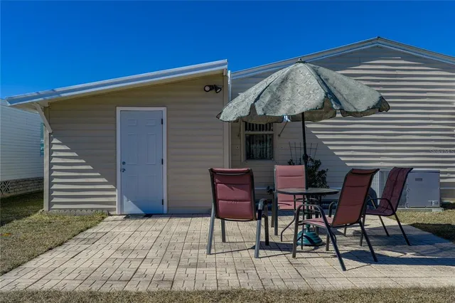 a view of a house with backyard porch and sitting area