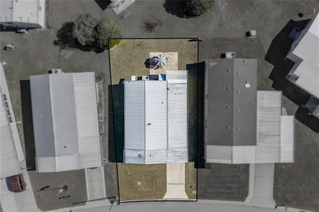 an aerial view of a house with a swimming pool yard and lake view