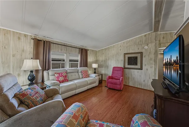 a living room with furniture or couch and a flat screen tv