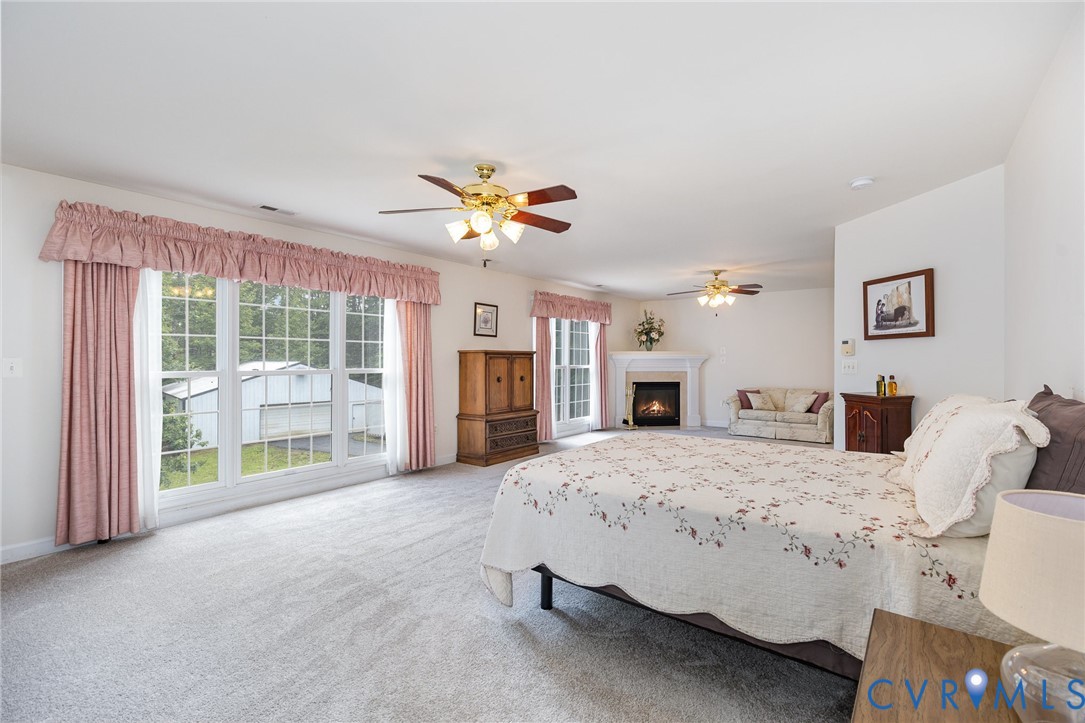 160 Walnut Ridge Drive Stafford, VA 22556 - Photo 17 of 43 Carpeted bedroom featuring a lit fireplace and a c