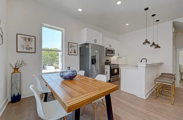 a kitchen with a table and chairs in it