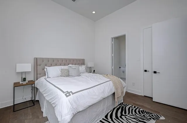 a bedroom with a bed and a lamp