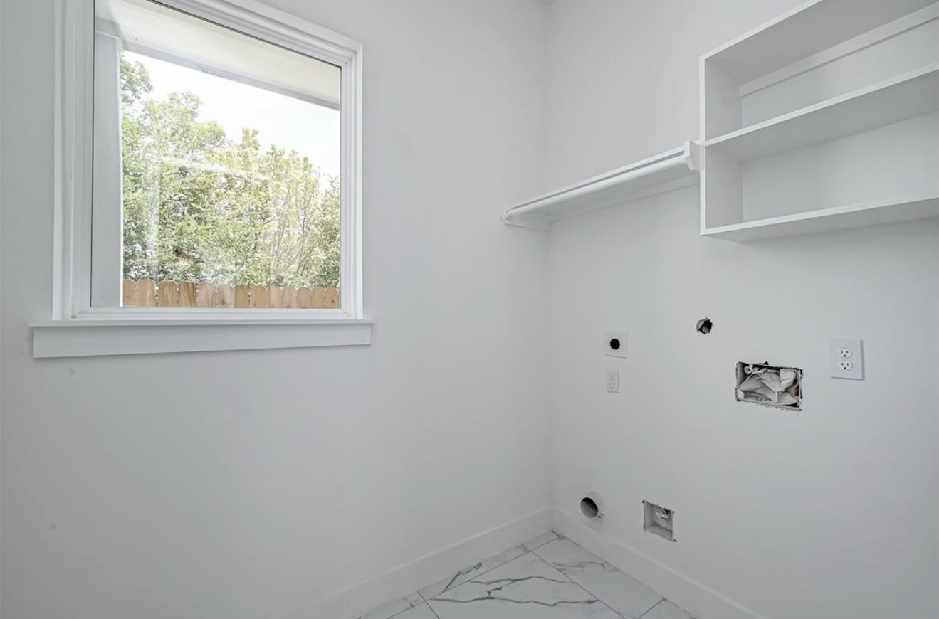 6127 West Montgomery Road Houston, TX 77091 - Photo 7 of 38 a bathroom with a window and a shower