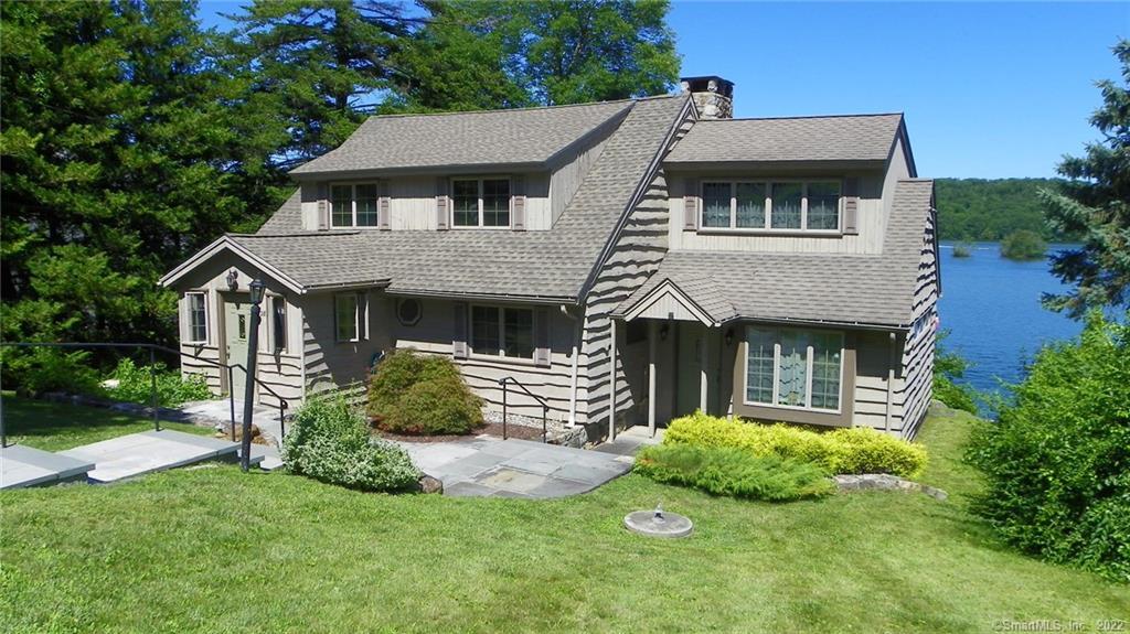 28 Eastview Road New Fairfield, CT 06812 - Photo 1 of 1 a front view of a house with a garden and plants