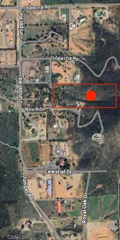 a view of a field with mountains in the background