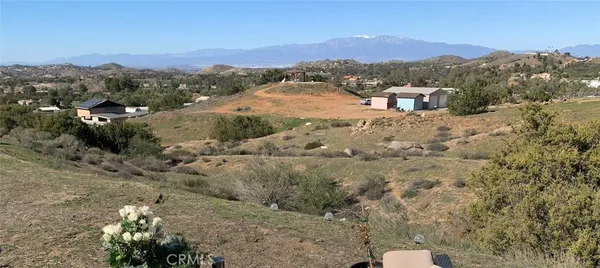a view of a yard with mountain and wooden fence