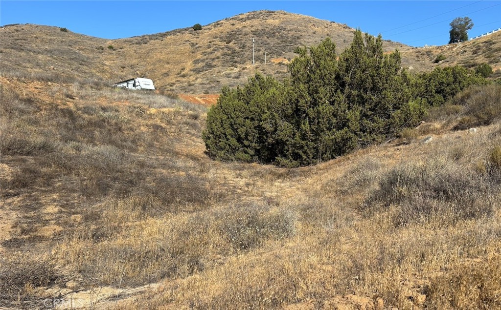 0 Niro Road Perris, CA 92570 - Photo 34 of 40 a view of a large mountain with trees in the background