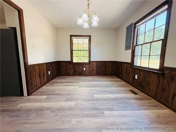 a view of an entryway with wooden floor and windows