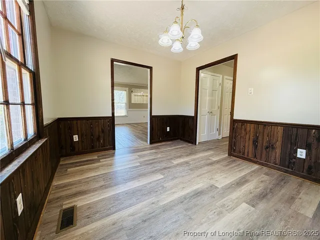 a view of a livingroom with furniture and chandelier