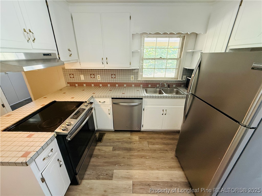 4355 Draughon Road Eastover, NC 28312 - Photo 7 of 20 a kitchen with a sink stove and refrigerator