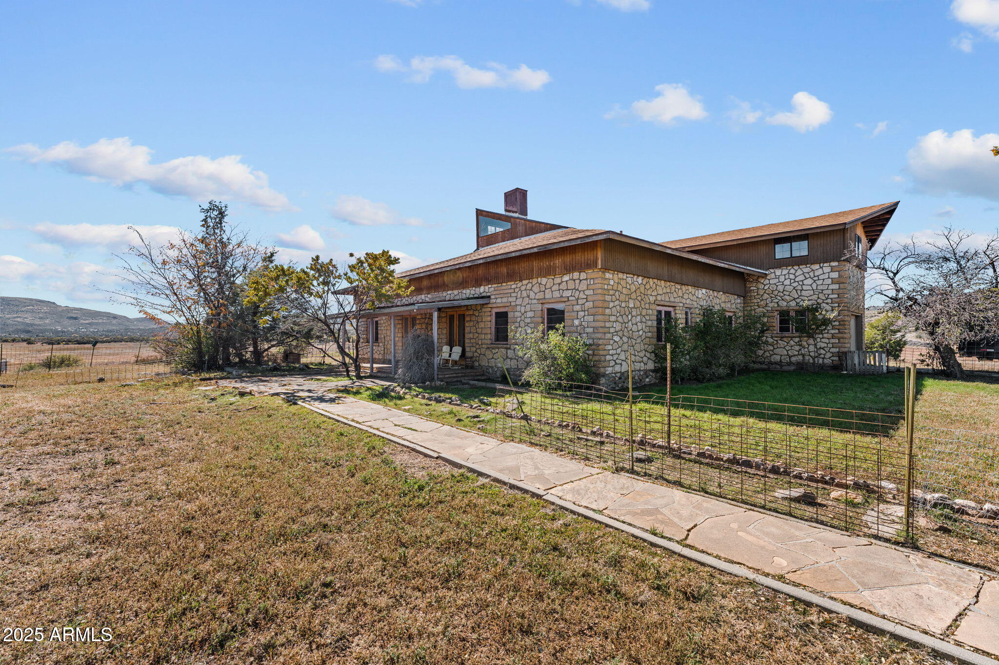 16057 Sickles Ranch Road Peeples Valley, AZ 86332 - Photo 6 of 39 a view of a house next to a yard